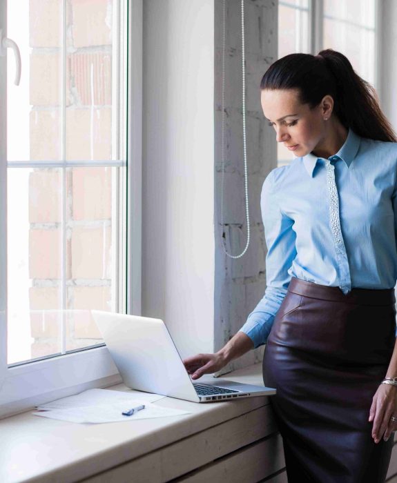 young-successful-happy-smiling-business-woman-on-l-PKLKAEE-1-scaled.jpg